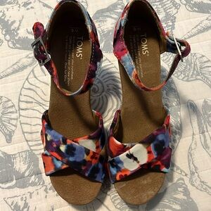 Tom’s sandals. Multi colored floral design. Has 3 1/2 inch heels.